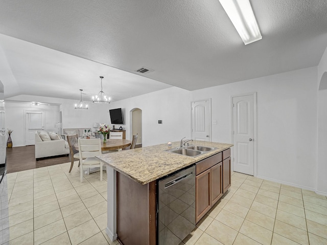 kitchen featuring visible vents, arched walkways, dishwashing machine, open floor plan, and a sink