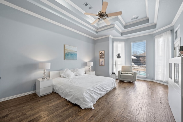 bedroom featuring a raised ceiling, visible vents, crown molding, and wood finished floors