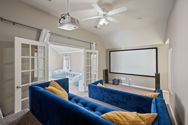 home theater featuring french doors, a ceiling fan, carpet flooring, vaulted ceiling, and baseboards