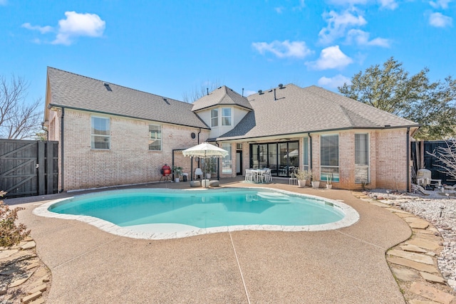 view of pool featuring fence, a fenced in pool, and a patio