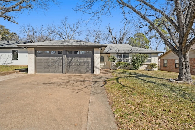 ranch-style home with a garage, concrete driveway, and a front yard