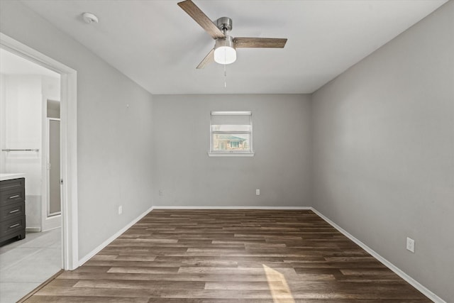 unfurnished bedroom with light wood-style floors, ensuite bath, baseboards, and a ceiling fan