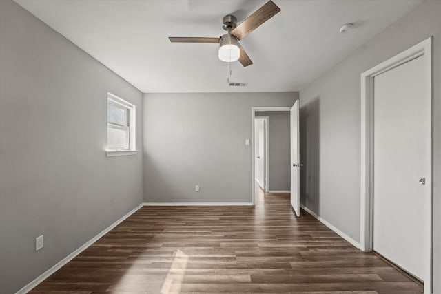 unfurnished bedroom with a ceiling fan, baseboards, visible vents, and wood finished floors