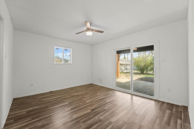 empty room featuring ceiling fan, baseboards, and wood finished floors