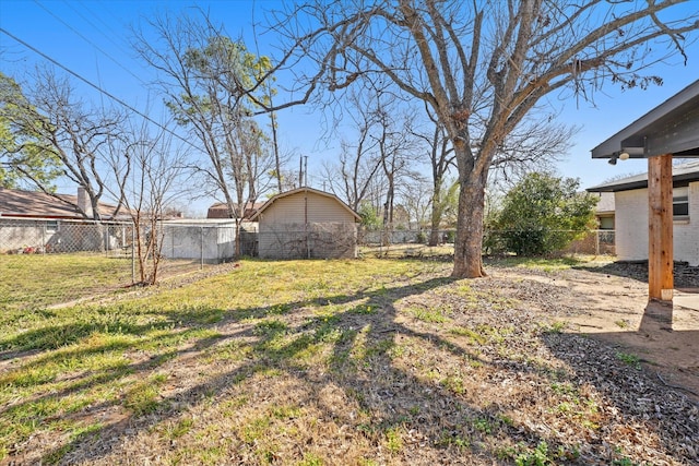 view of yard with an outdoor structure and a fenced backyard