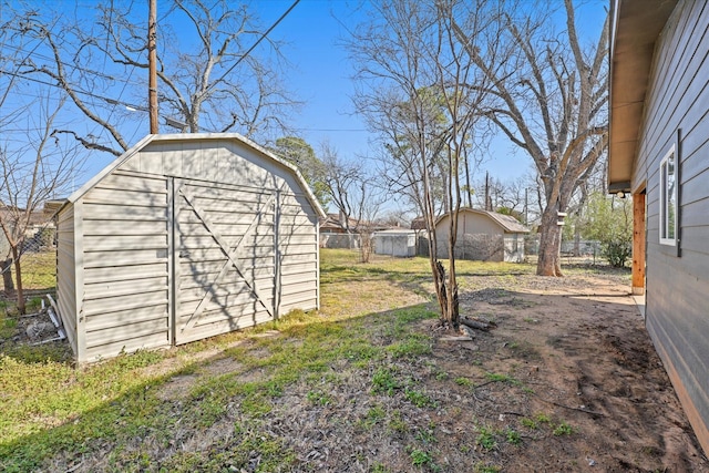 view of yard with an outbuilding and a storage shed