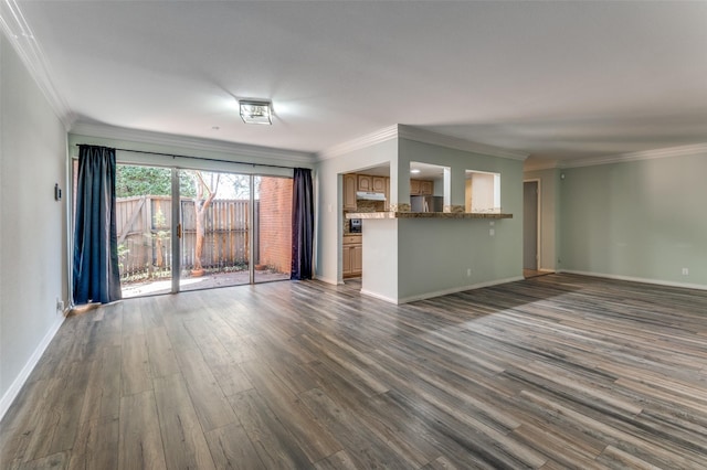 unfurnished living room with ornamental molding, dark wood finished floors, and baseboards