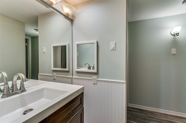 bathroom featuring a wainscoted wall, wood finished floors, and vanity