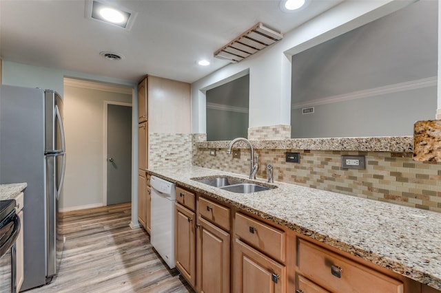 kitchen with light stone counters, a sink, visible vents, dishwasher, and crown molding