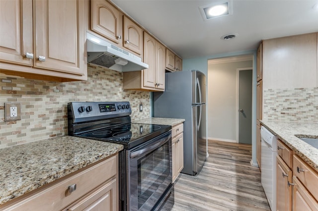 kitchen with visible vents, light wood-style flooring, appliances with stainless steel finishes, light stone countertops, and under cabinet range hood