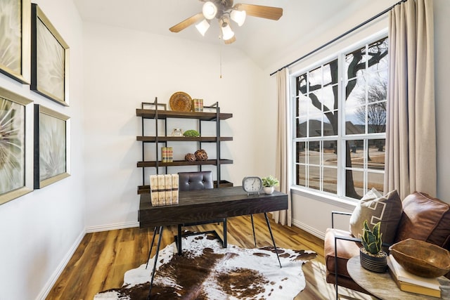 home office with lofted ceiling, a healthy amount of sunlight, baseboards, and wood finished floors