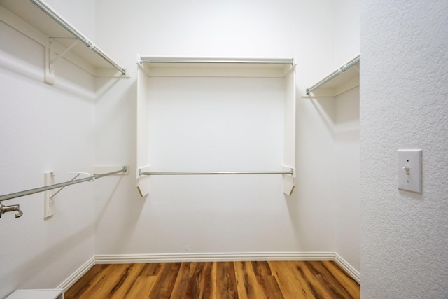 walk in closet featuring wood finished floors