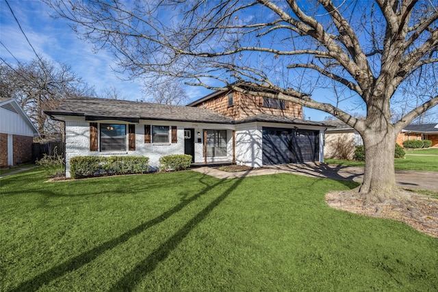 view of front of home featuring driveway, a shingled roof, an attached garage, a front yard, and brick siding