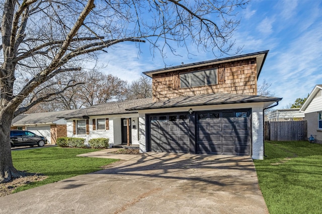 view of front of property with a garage, driveway, a front lawn, and fence