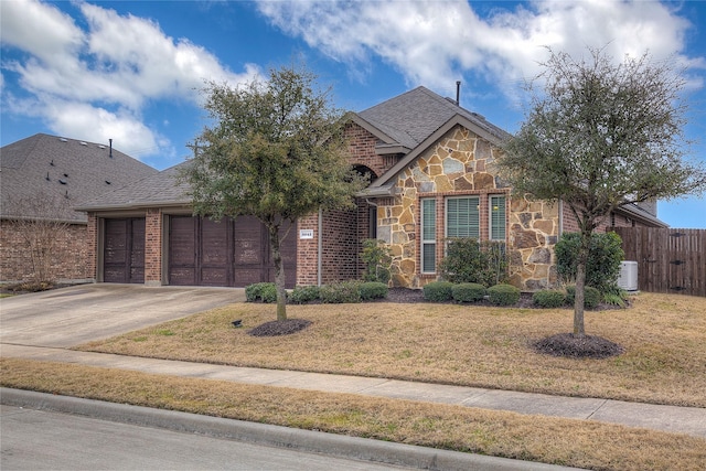 view of front facade featuring stone siding, brick siding, driveway, and a front lawn