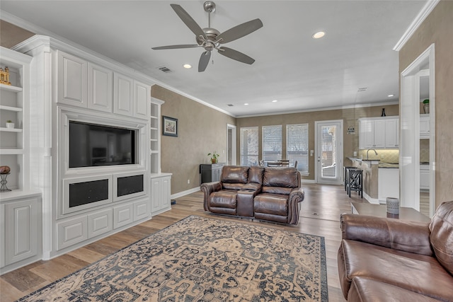 living area featuring visible vents, crown molding, ceiling fan, recessed lighting, and light wood-style flooring