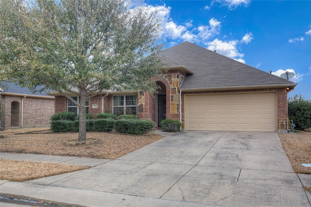 ranch-style home with a shingled roof, brick siding, driveway, and an attached garage