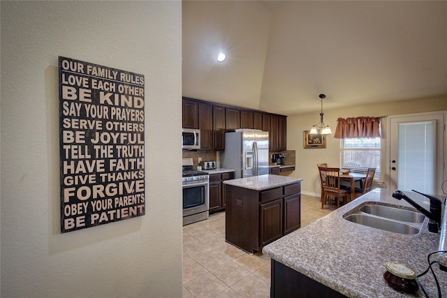 kitchen featuring a kitchen island, stainless steel appliances, dark brown cabinets, a sink, and light tile patterned flooring