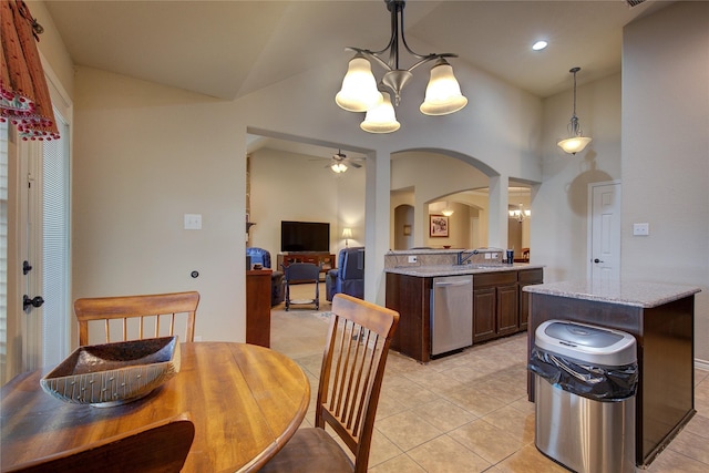 kitchen with arched walkways, dishwasher, vaulted ceiling, a sink, and ceiling fan with notable chandelier