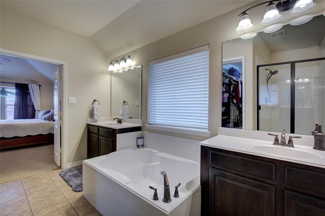 full bathroom with a stall shower, tile patterned flooring, a sink, and lofted ceiling