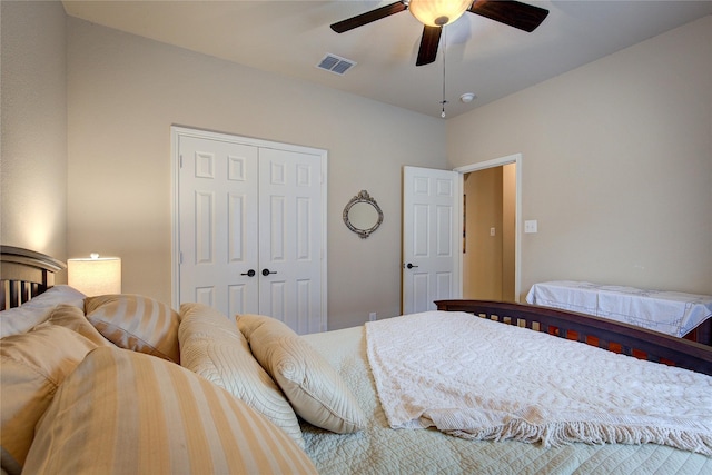 bedroom with a closet, visible vents, and a ceiling fan