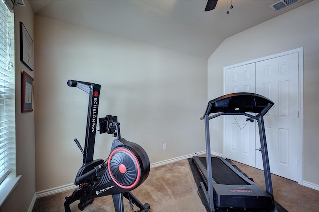 exercise area featuring carpet floors, a ceiling fan, visible vents, and baseboards