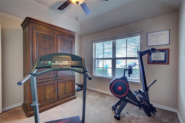 workout area with a ceiling fan, light carpet, and baseboards