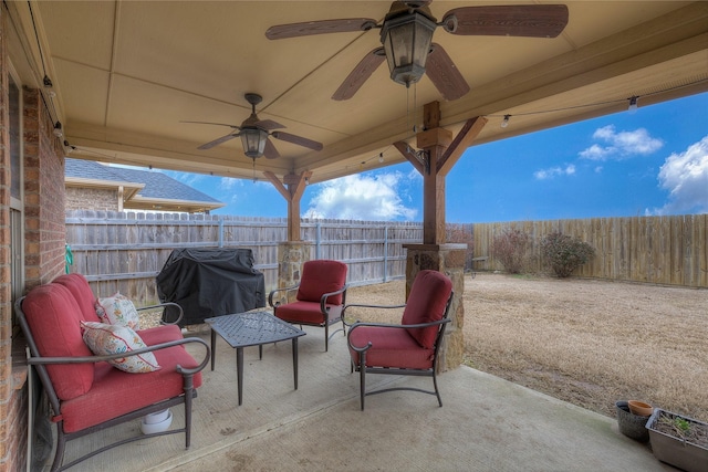 view of patio with grilling area and a fenced backyard