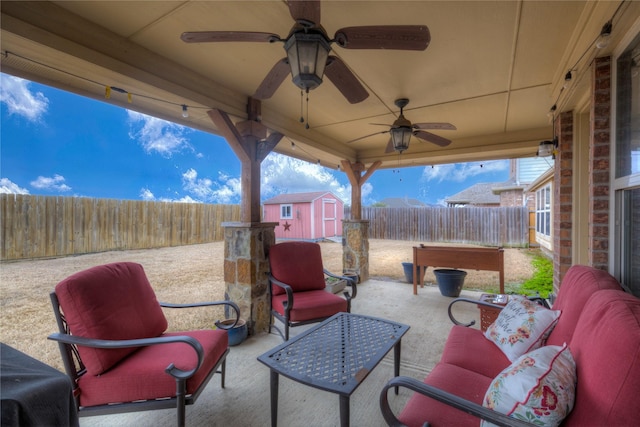 view of patio / terrace featuring a storage shed, an outdoor structure, a fenced backyard, and an outdoor living space