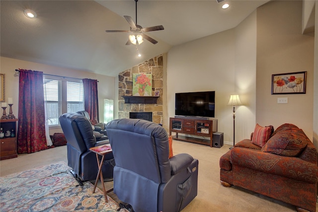 living area featuring lofted ceiling, ceiling fan, a fireplace, and light colored carpet