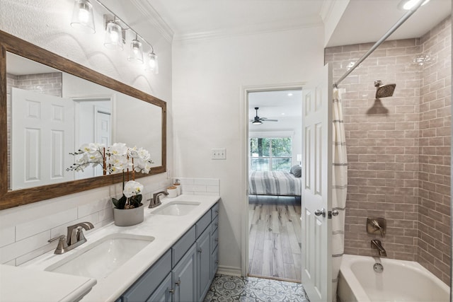 ensuite bathroom with ornamental molding, a sink, and shower / bathtub combination with curtain