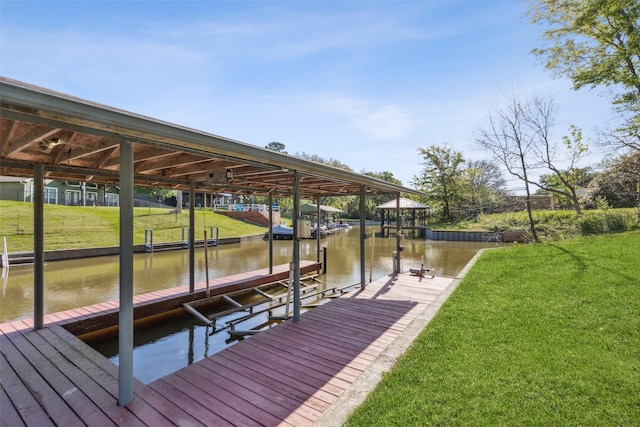 view of dock with a lawn, a water view, and boat lift