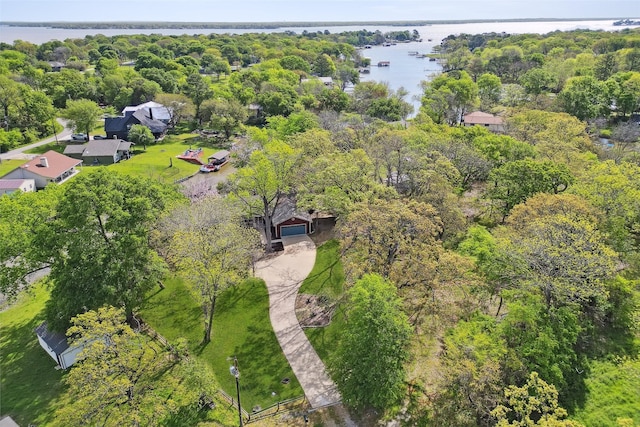 aerial view with a water view and a forest view