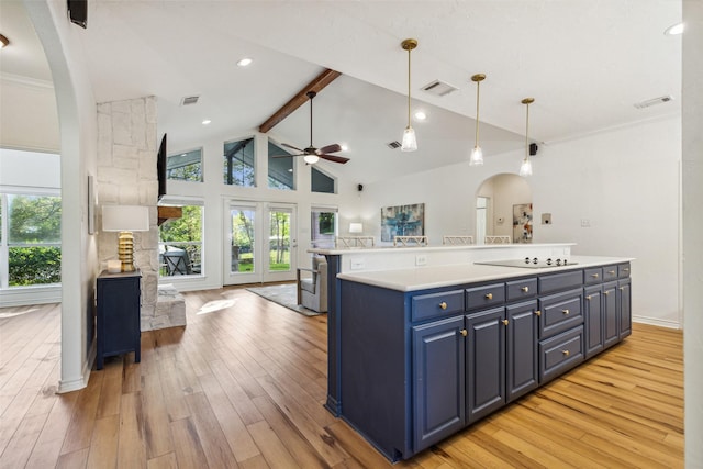 kitchen featuring blue cabinets, open floor plan, visible vents, and light wood-style flooring