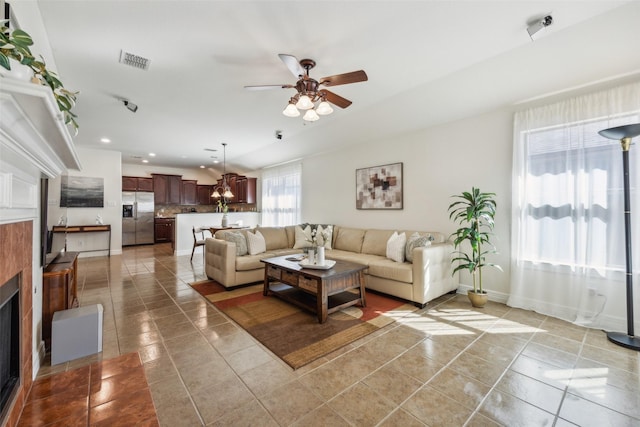 living room featuring light tile patterned floors, visible vents, a ceiling fan, and recessed lighting