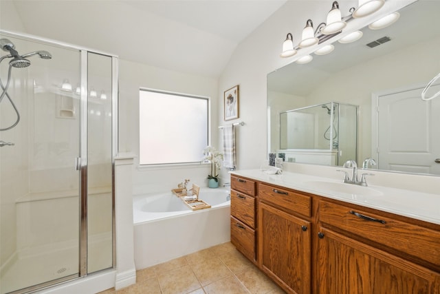 bathroom with a stall shower, visible vents, lofted ceiling, a garden tub, and tile patterned flooring