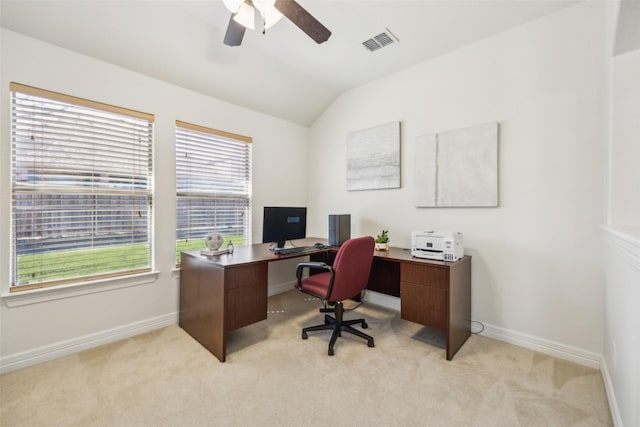 home office featuring light colored carpet, visible vents, lofted ceiling, and baseboards