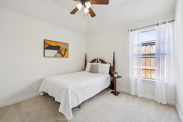 carpeted bedroom featuring lofted ceiling, ceiling fan, and baseboards