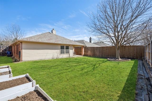 exterior space featuring a yard, brick siding, a fenced backyard, and a vegetable garden