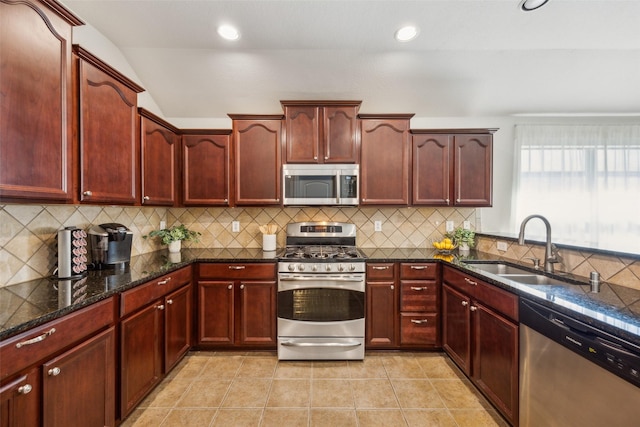 kitchen with dark brown cabinets, appliances with stainless steel finishes, and a sink