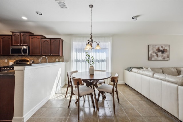 dining space featuring baseboards, visible vents, tile patterned floors, a notable chandelier, and recessed lighting