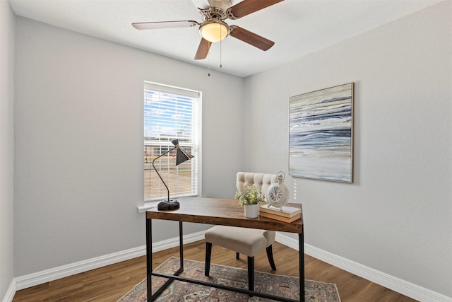 home office featuring wood finished floors, a ceiling fan, and baseboards