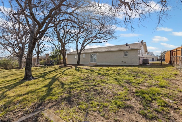 view of yard with fence and central AC