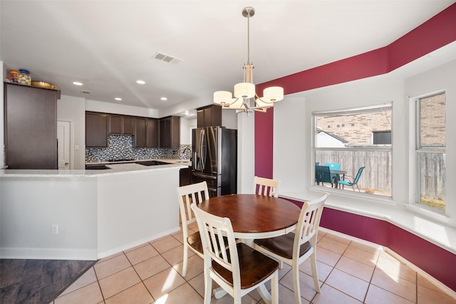 dining area featuring light tile patterned floors, visible vents, a chandelier, and recessed lighting