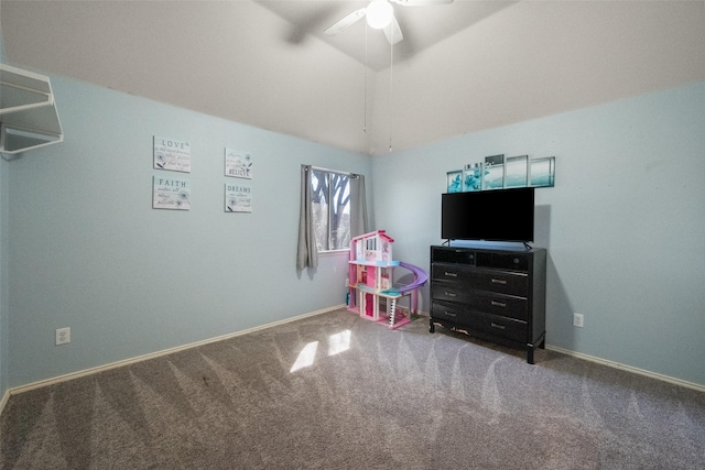 recreation room with lofted ceiling, baseboards, a ceiling fan, and carpet flooring