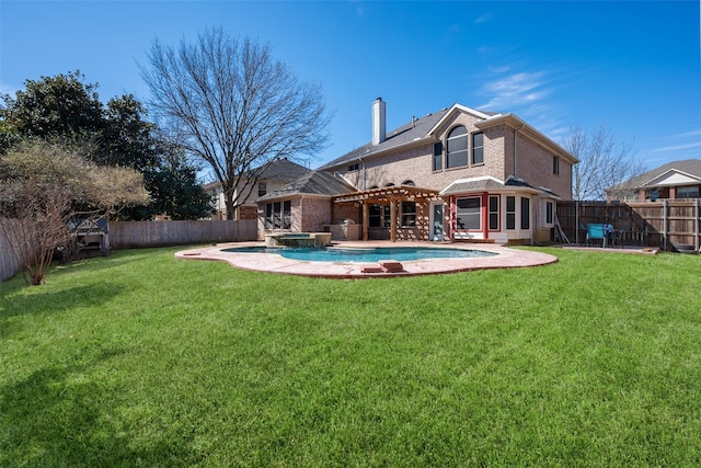 rear view of house with a fenced backyard, a chimney, and a lawn