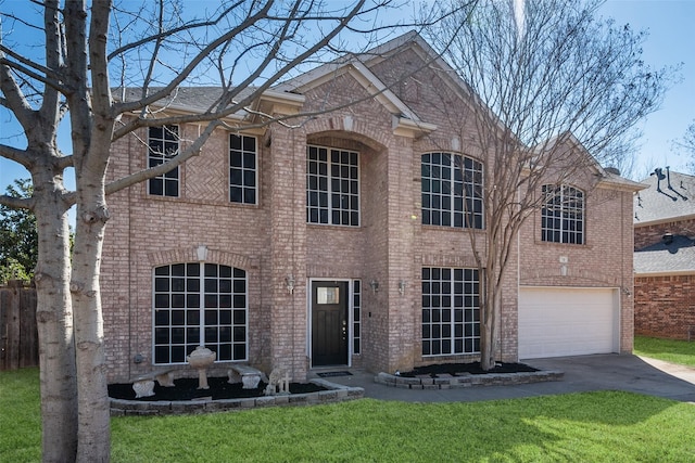 view of front facade featuring an attached garage, a front yard, aphalt driveway, and brick siding