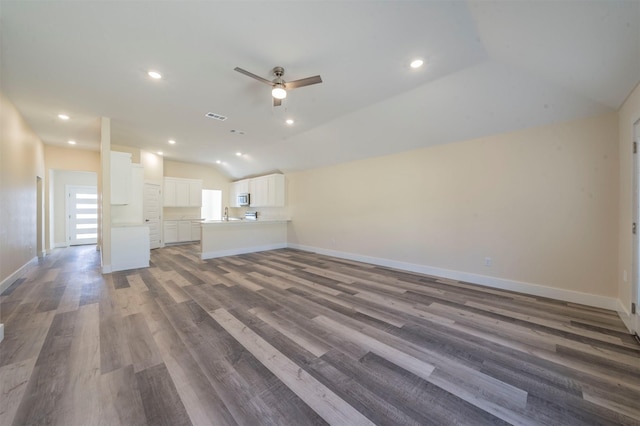 unfurnished living room with vaulted ceiling, ceiling fan, visible vents, and baseboards