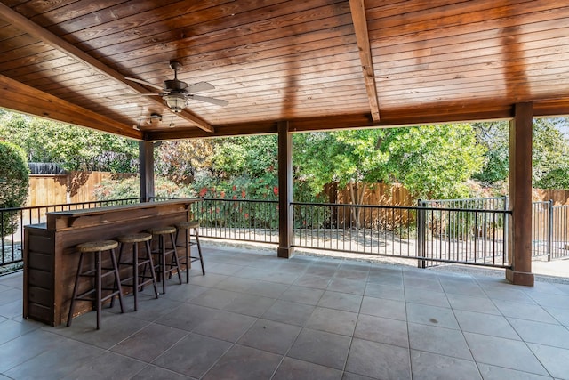 view of patio / terrace featuring a fenced backyard, ceiling fan, and outdoor dry bar