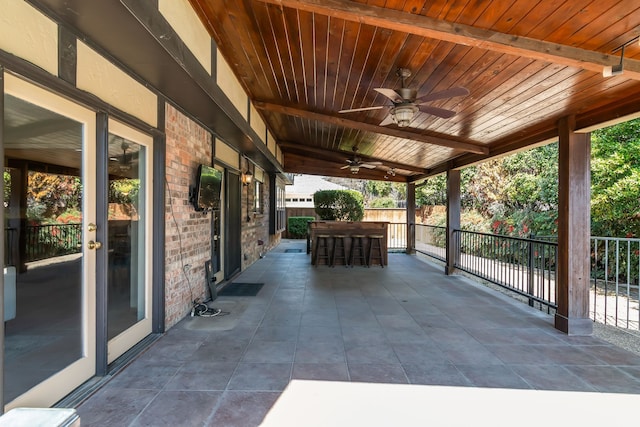 view of patio with ceiling fan, fence, and outdoor dining space